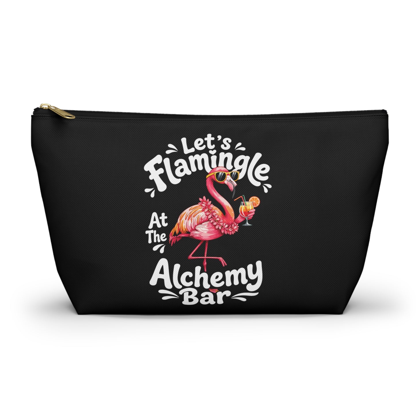 A black zippered cosmetic pouch featuring a colorful graphic of a pink flamingo holding a cocktail, surrounded by the text 'Let's Flamingle At The Alchemy Bar' in white and pink lettering.