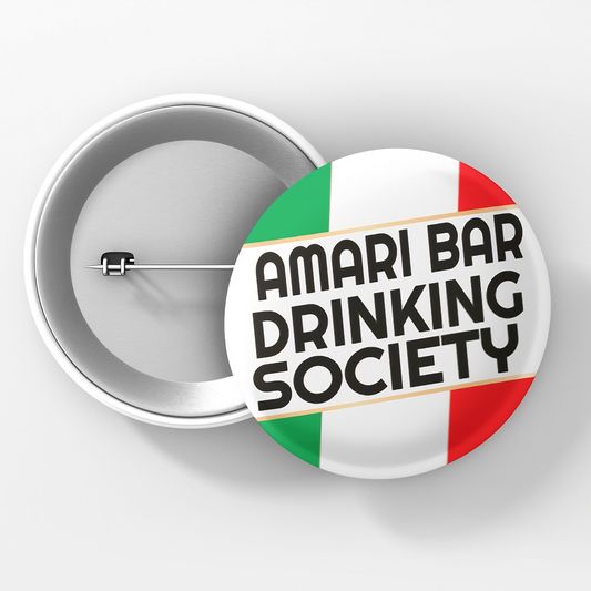 A round pin button with a white background featuring text and the Italian flag colors, designating to the Amari Bar Drinking Society.