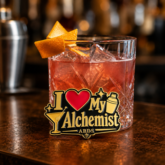 I Love My Alchemist enamel lapel pin with gold lettering, a red heart, martini glass, cocktail shaker, and black background.
