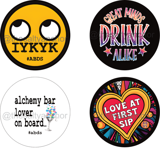 A set of six round drink coasters with various nautical and playful designs, including text and maritime-themed illustrations.